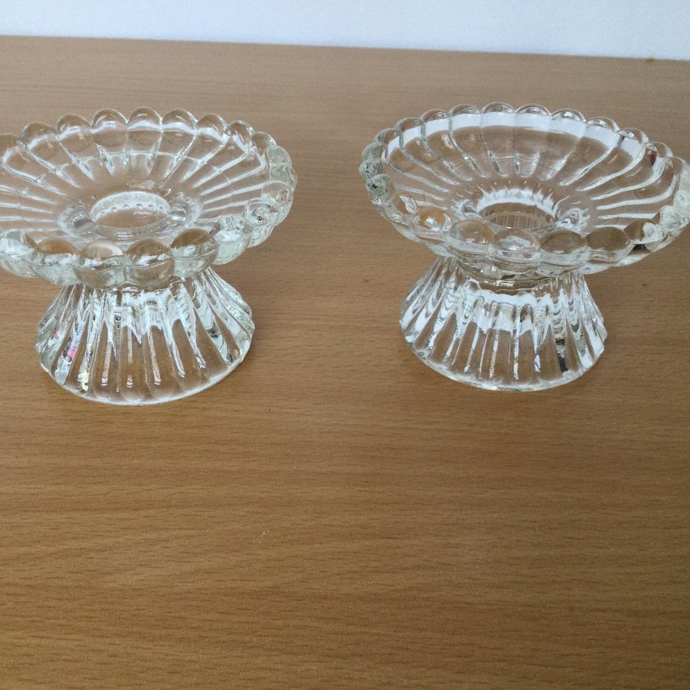 A pair of clear glass candlestick holders small scalloped edge